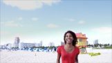 A woman in red top smiling at the beach