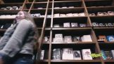A woman in front of book shelves