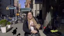 A woman walking with a handbag in a street