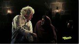 Old man holding another man's hand