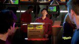A group of people standing in front of a box.