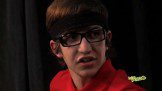 A young man wearing glasses and a red shirt.
