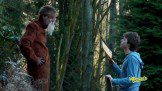 Boy taking instruction from old man at jungle