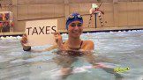 Woman within water holding Texax hoarding