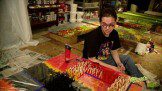A painter in black t shirt sitting on the floor