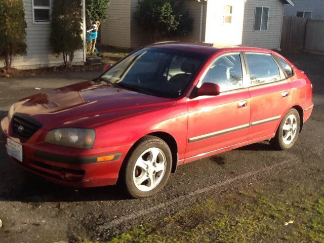 A red car parked in a parking lot.