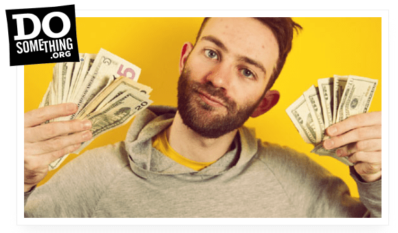 A man holding up a stack of money.