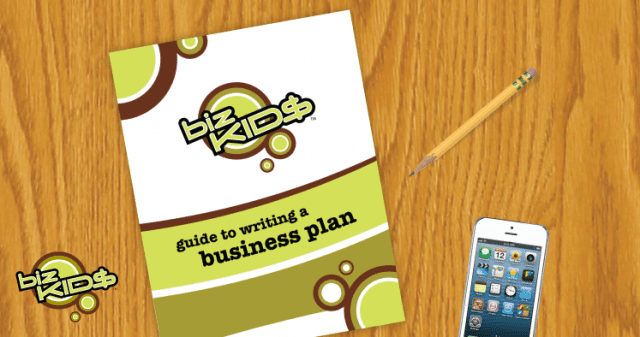 A business plan on a table next to a cell phone.