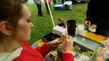 A woman at a playground counting money