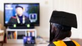A scholar is looking at the TV