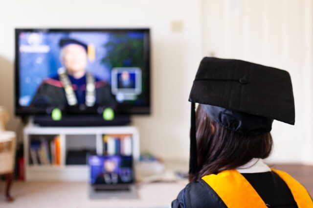 A scholar is looking at the TV