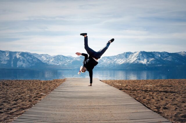 a man showing a dance move near a sea