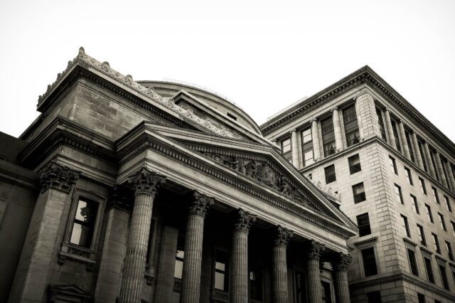 A black and white photo of a building with columns.