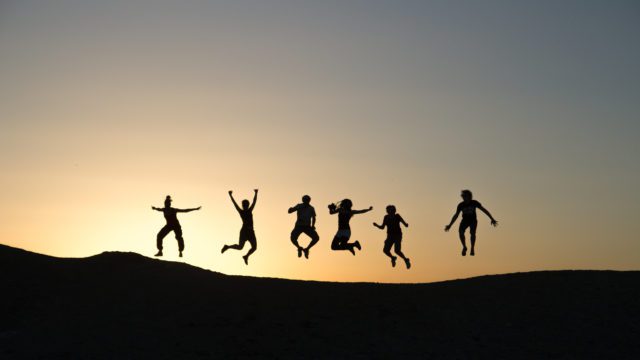 Shadows of some people jumping in air