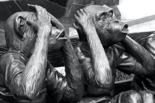 Two monkeys idols close their eyes and ears with palms