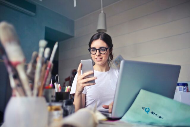 a woman checking her phone while working