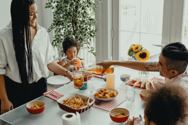 A family is having a meal together at the table.